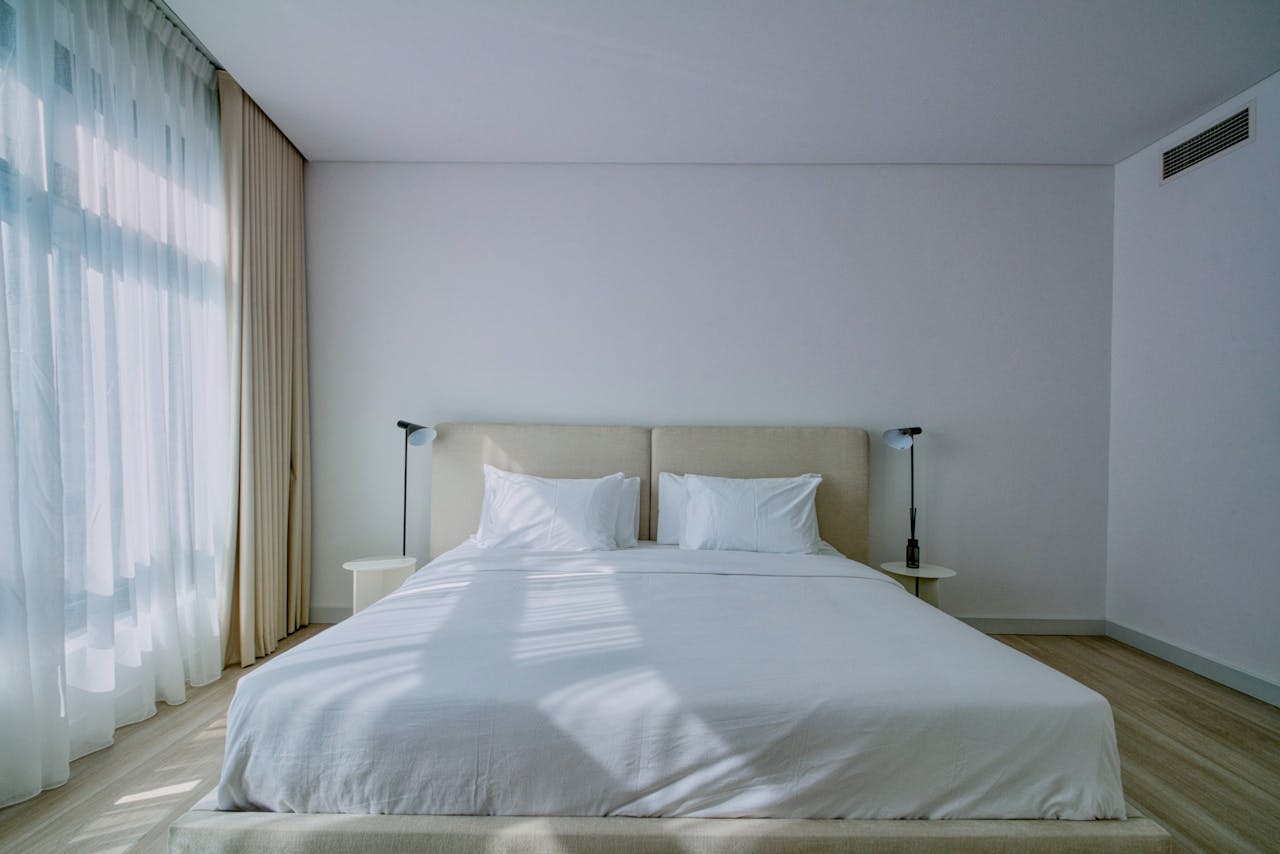 The Art of Drawing Readers In: Your attractive post title goes here A stylish, airy bedroom interior with soft natural light and elegant furnishings.